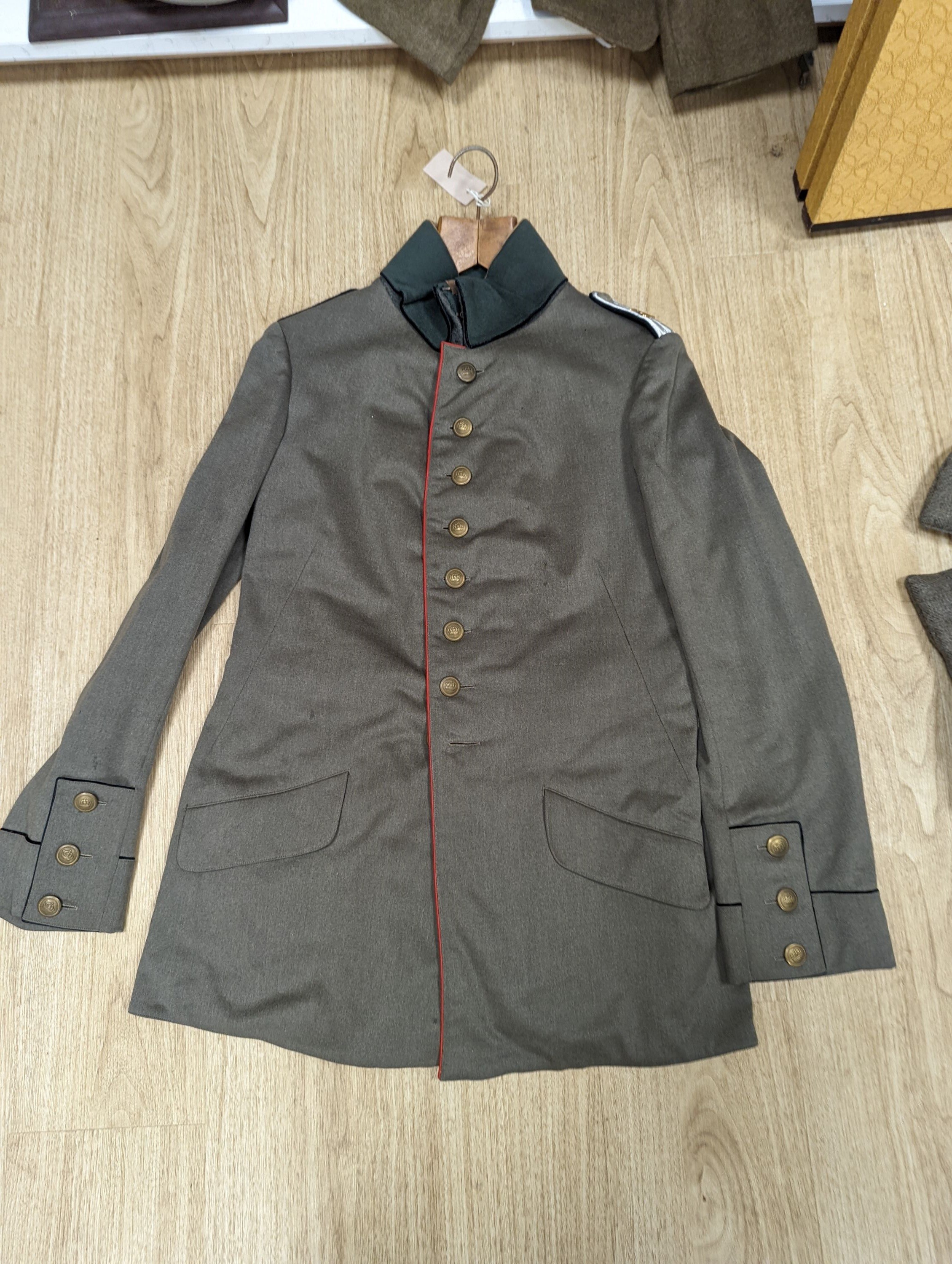 Two German WWI jackets and a similar British jacket.